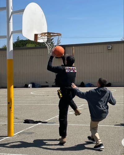 San Joaquin Probation Officer playing basketball with children