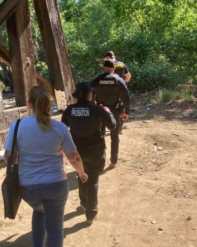 SJ Probation officers walking to homeless camp